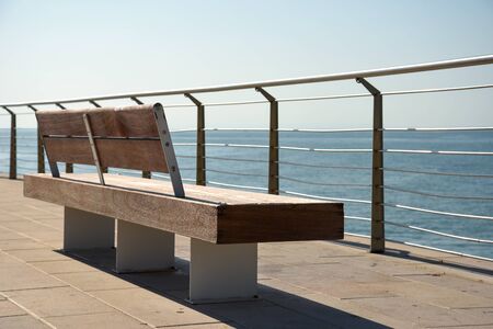 Benches in the touristic harbor by morningの写真素材