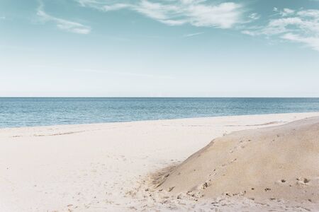 Panorama of a beautiful beach in Monopoli - Puglia (the beach is located at the "Capitolo"). great view of a white beach with pastel colored skyの写真素材