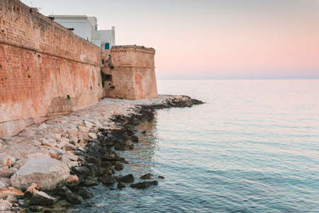 Overview of the old city walls in the historic center of Monopoli in Puglia (Apulia - southern Italy) - View of the ancient beach called "portavecchia"の写真素材