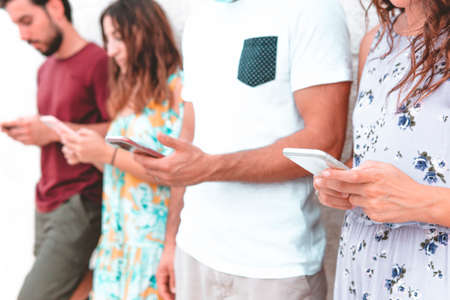 Group of friends using smartphone outdoors - Young people spend time together with internet -...