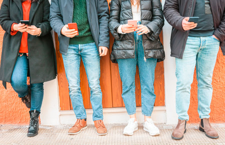 Group of friends using smart phone app - Teen addiction to new technology trends - Concept of...