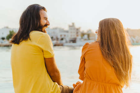Happy couple on seaside summer vacation laughs and jokes together - lifestyle and wellness conceptの写真素材