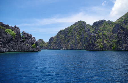 A big rocky island in the Philippines archipelago. The water of the ocean is calm and rippling...