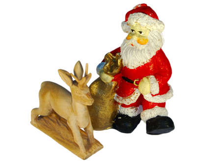 a wooden deer and a santa made of wax in a composition on whiteの写真素材