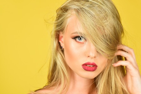 Beautiful woman with smooth long hair, beauty hairstyle, red lips and perfect skin. Care and hair products. Hair cosmetics. Haircare cosmetic.の写真素材