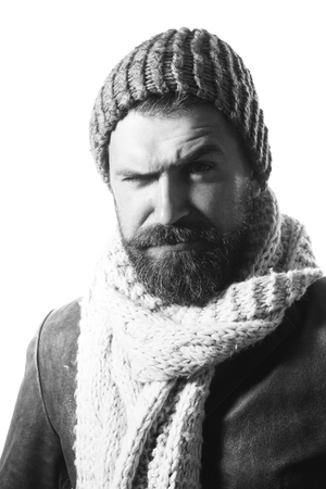 Perfect style. Confident bearded man wearing hat, scarf and leather jacket. Attractive macho with beard looking at camera. Black and white.の写真素材