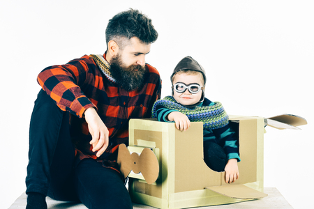 Adopting a child. Adopted boy in new family. Portrait of funny kid on a background. Family games indor.の写真素材