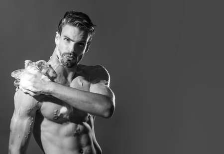 Morning washing, everyday life. Man washed in shower. Handsome sexy muscular man taking shower in bathroom. Attractive guy having shower after long day. Spa, hygiene, relax. Copy space.Black and whiteの写真素材