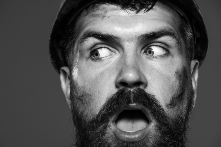 Man builder. Builder in protective helmet. Male builder. Building, business, construction, industry and people concept - closeup amazed builder, architect, contractor, engineer in hardhat. Black&whiteの写真素材