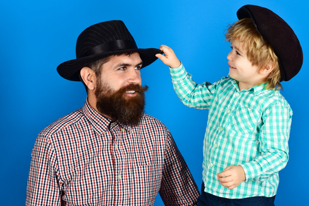 Family concept. Happy father and son in checkered shirts looking at each other. Father's day celebration. Smiling boy and bearded father. Parenthood concept. Happy dad with son. Parenting. Fashion.の写真素材