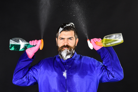 Bearded man with cleaning equipment. Cleaning concept. Portrait of serious bearded man with cleaning...