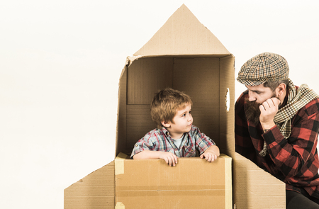 Childhood dream. Father`s day. Cardboard spaceship. Happiness. Space adventures. Kid astronaut. Son play with father. Family concept. Happy family. Cosmonautics Day.の写真素材