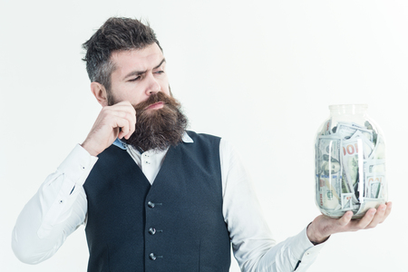 Business concept. Saving money concept. Business success concept. Digital money concept. Finance. Bank advertising. Piggybank. Bearded man holds piggy-bank.の写真素材