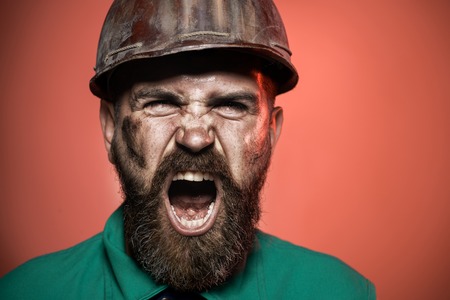 Screaming architect in suit with construction helmet. Closeup. Man builder. Close up engineers working. Construction worker in hard hat. Builder working with construction helmet.の写真素材