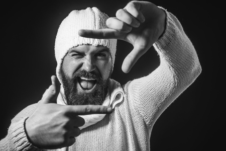 Just imagine. Creative bearded man making frame gesture. Emotions, facial expressions, feelings, body language, signs. Happy hipster smile and using fingers making imaginary photo. Black and white.の写真素材