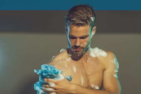 Handsome man, bearded hipster in shower. Attractive bearded guy washing in bathroom.の写真素材