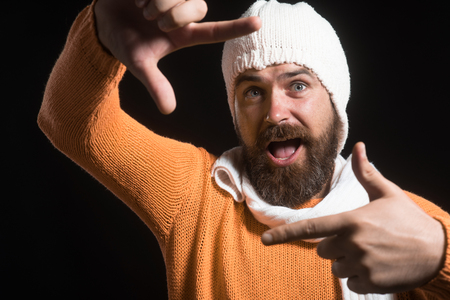 Cheerful bearded man creating frame with fingers. Real people. Cool, creative, confident, aspirations concept. Man using hand framing to create viewfinder. Imaginary selfie photo.の写真素材