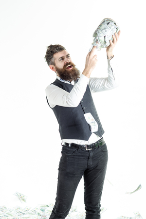 Excited bearded man holds jar with banknotes. Business concept. Saving money concept. Business success concept. Digital money concept. Finance. Bank. Piggybank with money.の写真素材