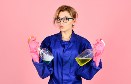 Portrait of girl with cleaning products. Young smiling cleaner isolated on pink background. Smiling housewife woman with cleaning tools isolated on pink background. Cleaning concept. Cleaners.の写真素材
