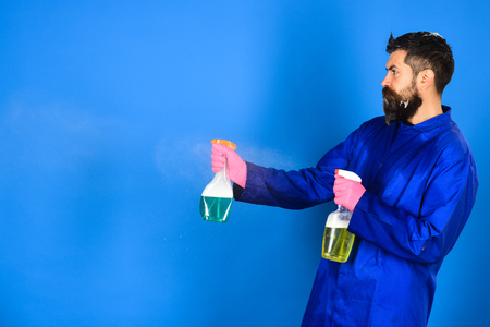 Bearded man with cleaning equipment. Serious bearded man with cleaning spray. Cleaning concept.