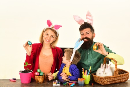 Happy easter! Isolated white background. Mother, father and kid painting Easter eggs. Easter eggs...