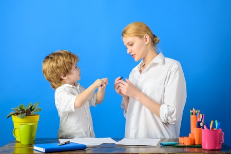 Mother and son draw. Early learning and daycare concept. Mom with little son at home drawing with color pencil. Creative kid at playschool. Family time. Little boy draws with mother. Education conceptの写真素材