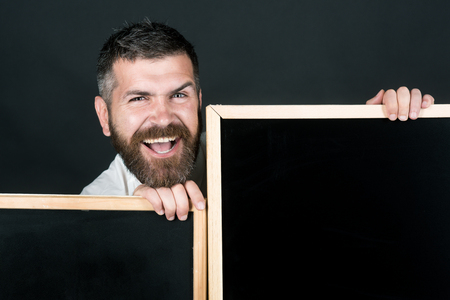 Bearded man, businessman, teacher, professor with two empty boards. Back to school. Business concept. Attractive man with empty signboards. Happy guy hold placards ready for text, slogan or product.の写真素材