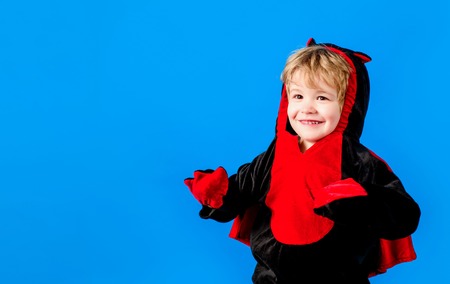 Boy in costume celebrating Halloween. Trick or treating on Halloween party. Kid in fancy costume....