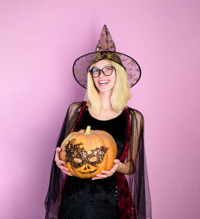 Halloween witch with carved pumpkin. Trick or treat. Halloween girl with pumpkins. Celebrating Halloween. Happy witch with pumpkin Jack o lantern. Happy Halloween weekends. Sexy witch vampire concept.の写真素材