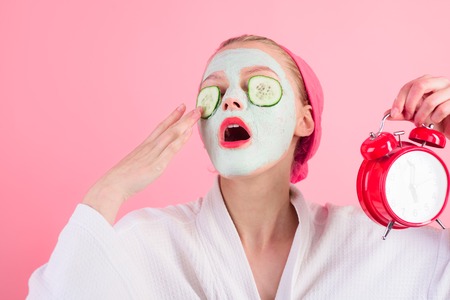 Sleeping girl with cosmetic mask. Mask with cucumber slices on eyes. Facial clay mask. Spa. Cosmetic mask. Clean skin. Morning. Spa treatments. Health. Clean skin.の写真素材