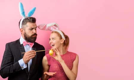 Family celebrate Easter. Happy family. Couple painting eggs for Easter. Decorating eggs ideas. Spring holidays. Season sale. Man with bunny ears. Copy space.の写真素材