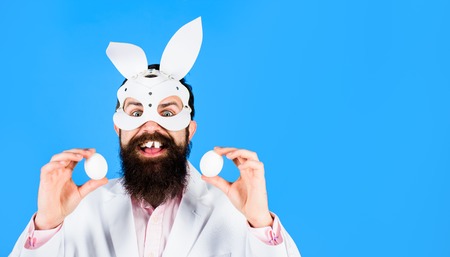 Happy Easter! Easter day. Spring holiday. Surprised bearded man holds white eggs. Egg hunt. Easter...