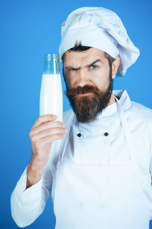 Restaurant dairy meal, organic healthy food concept - serious confectioner, chef, cook or baker in...
