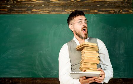 Teacher with laptop and books. Reading digital copy, online education and learning