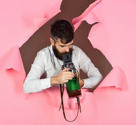 Retro photocamera. Photography, media, journalism concept. Man with beard&mustache with old...
