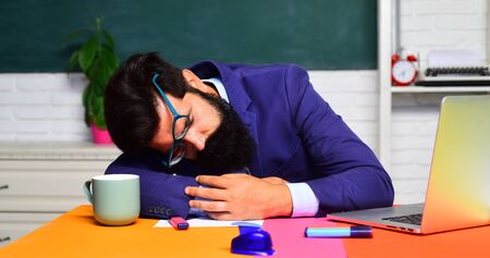 Back to school. Teachers day. Bearded teacher. Student indoors. Tired professor sleep in class. Education concept. School concept. Bearded professor. High school.の写真素材
