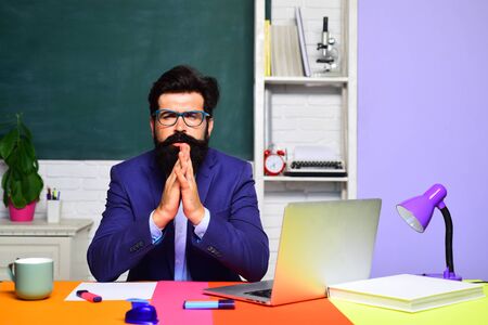 Back to school. Teachers day. Bearded teacher indoors. Serious professor in class. Online test. Student and tutoring education concept. School concept. Bearded professor. High school.の写真素材
