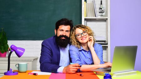 Back to school. World teachers day. University students at college. Portrait of smiling young teachers. Portrait of couple university students indoors. Students and tutoring education concept.の写真素材