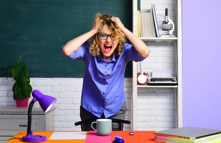 Back to school. Crazy teacher. Hard schoolwork. Homework. Student preparing for test or exam. Exam in college. Hard exam. Angry teacher.の写真素材