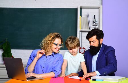 Happy family. Boy from elementary school. Parents encouraging their little son before first day of...