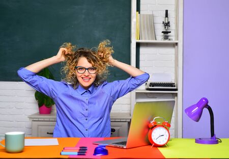 Happy female student studying in school. High school concept. Education. Funny student studying in university. Student in college. Student preparing for test or exam. Beautiful teacher in classroom.の写真素材