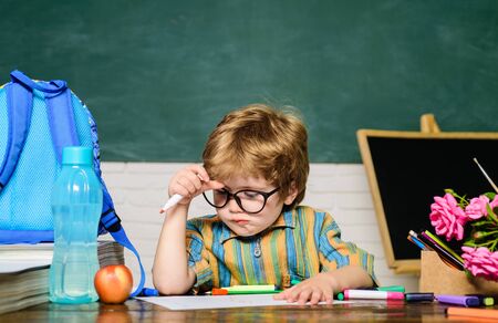 Back to school. Brainstorm. Schoolboy. Homework. Pupil in classroom. Lessons. School subjects. Science. Education concept. Nerd. Elementary school.の写真素材