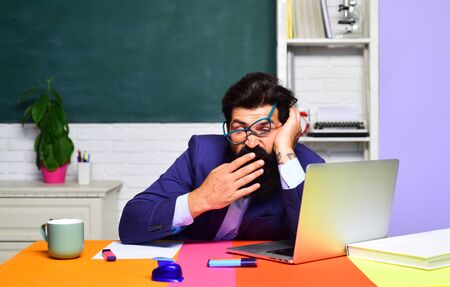 Back to school. World teachers day. Learning and education. Tired male university student indoors.の写真素材