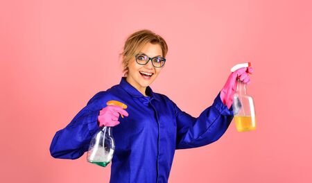 Housewife cleaner. House cleaning service, cleaning supplies, hygiene and work concept. Housewife with cleaning supplies. Service to support hygiene. Happy girl in household gloves with cleaning toolsの写真素材
