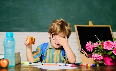 Primary school kid eat lunch in classroom. School lunch with apple. Healthy dinner in elementary school. Healthy breakfast for child. Delicious food for lunch. School lunch with tasty food on table.の写真素材