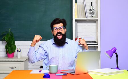 Creative happy smiling student in glasses. Student studying in classroom. Funny young teacher in classroom. University student at college. World teachers day. Portrait of male student in university.の写真素材