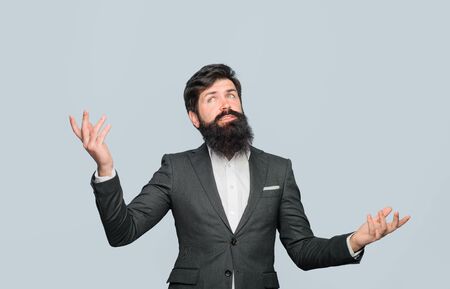 Thoughtful handsome businessman looking up. Businessman company leader CEO boss executive. Pensive bearded man in suit. Successful business man at office. Bearded man portrait. Handsome stylish man.の写真素材