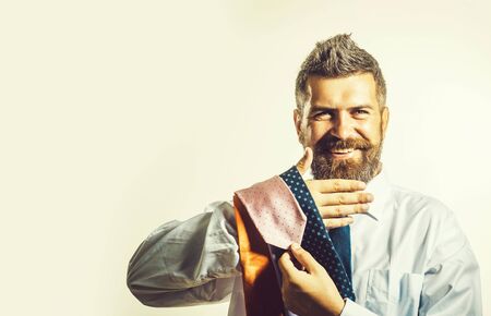 Businessman choosing necktie in mall or clothing store. Men's style. Tie collection in men's shop.の写真素材