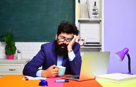 Knowledge and educational school concept. Tired teacher sleeping in classroom. Hard work. School job. Teacher preparing for university exams. Education concept. World teachers day. Back to school.の写真素材