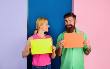Smiling couple holding advertising board. Advertising. Sale. Online shopping. Advertising banner. Seasons sale. Discount. Black friday. Marketing. Add. Copy space for text.の写真素材